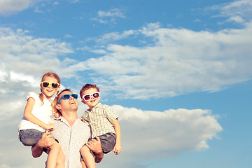 Image showing Father and children playing in the park  at the day time.