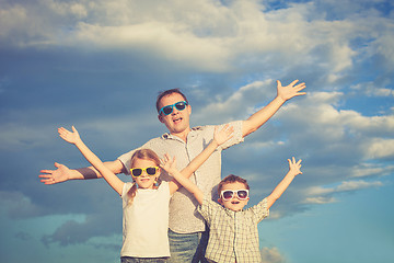 Image showing Father and children playing in the park  at the day time.