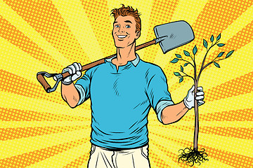 Image showing Man gardener with a shovel and sapling