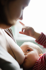 Image showing Woman breastfeeding her child