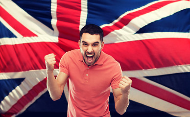 Image showing angry man showing fists over brittish flag