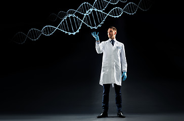 Image showing scientist in lab coat and medical gloves with dna