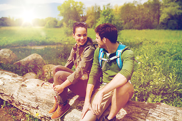 Image showing smiling couple with backpacks in nature