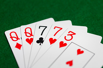 Image showing poker hand of playing cards on green casino cloth