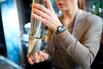 Image showing close up of bartender with cocktail shaker at bar