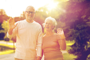 Image showing senior couple hugging in city park