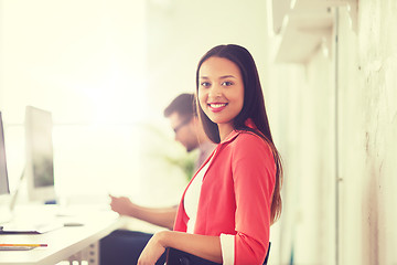 Image showing happy african woman with computer at office