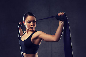 Image showing woman with expander exercising in gym