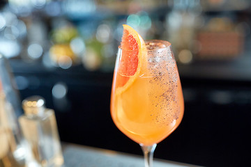 Image showing glass of grapefruit cocktail at bar