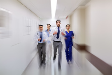 Image showing group of medics walking along hospital