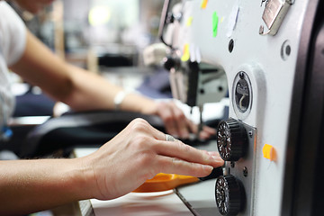 Image showing Sewing. Seamstress on the machine.