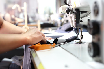 Image showing Sewing. Seamstress on the machine.