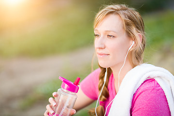 Image showing Young Fit Adult Woman Outdoors With Towel and Water Bottle in Wo