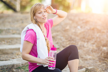 Image showing Young Fit Adult Woman Outdoors With Towel and Water Bottle in Wo