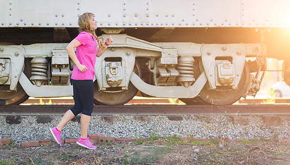 Image showing Young Fit Adult Woman Outdoors During Workout Listening To Music