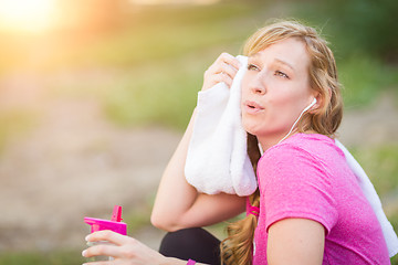 Image showing Young Fit Adult Woman Outdoors With Towel and Water Bottle in Wo