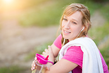 Image showing Young Fit Adult Woman Outdoors With Towel and Water Bottle in Wo