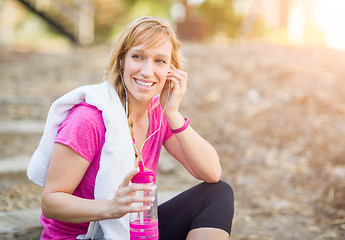 Image showing Young Fit Adult Woman Outdoors With Towel and Water Bottle in Wo