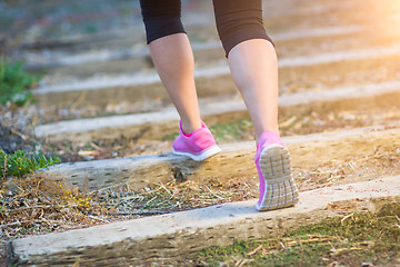 Image showing Young Fit Adult Woman Outdoors Walking or Running Up Wooden Step