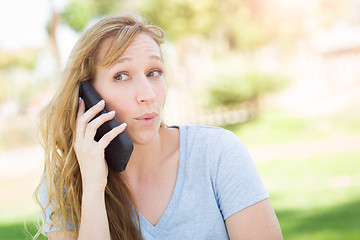 Image showing Young Adult Woman Outdoors Talking on Her Smart Phone.