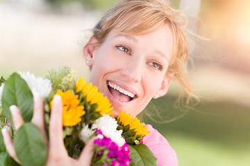 Image showing Outdoor Portrait of an Excited Young Adult Brown Eyed Woman Hold