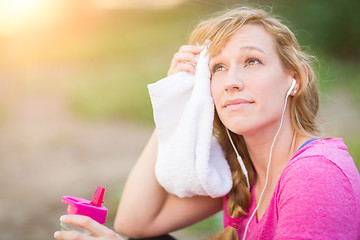 Image showing Young Fit Adult Woman Outdoors With Towel and Water Bottle in Wo