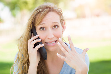 Image showing Stunned Young Woman Outdoors Talking on Her Smart Phone.