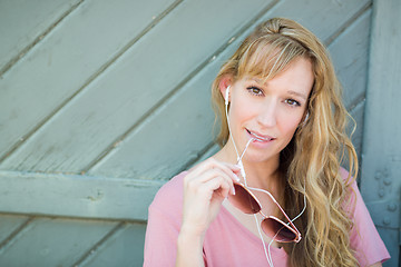 Image showing Outdoor Portrait of Young Adult Brown Eyed Woman With Sunglasses