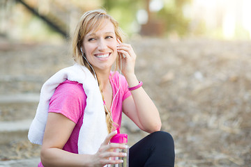 Image showing Young Fit Adult Woman Outdoors With Towel and Water Bottle in Wo