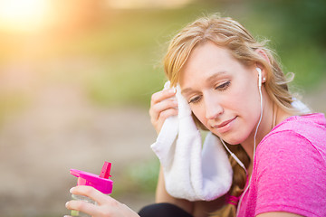 Image showing Young Fit Adult Woman Outdoors With Towel and Water Bottle in Wo