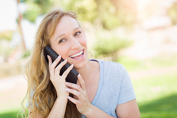 Image showing Young Adult Woman Outdoors Talking on Her Smart Phone.