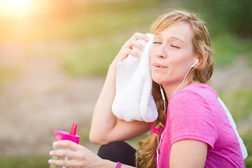 Image showing Young Fit Adult Woman Outdoors With Towel and Water Bottle in Wo