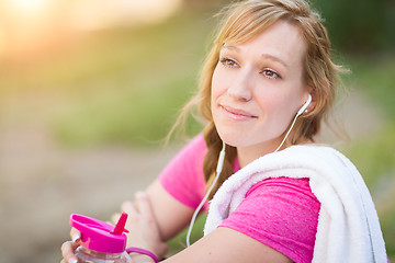 Image showing Young Fit Adult Woman Outdoors With Towel and Water Bottle in Wo