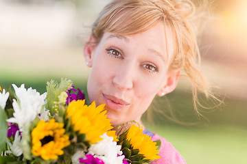 Image showing Outdoor Portrait of an Excited Young Adult Brown Eyed Woman Hold