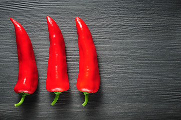 Image showing Sweet red Kapia peppers on a dark shale stone background