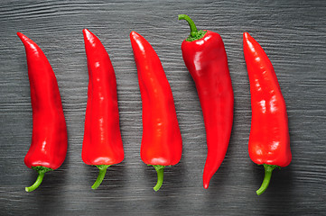 Image showing Sweet red Kapia peppers on a dark shale stone background