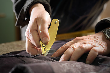 Image showing Furrier cut leather sewing scum Cutting mink fur