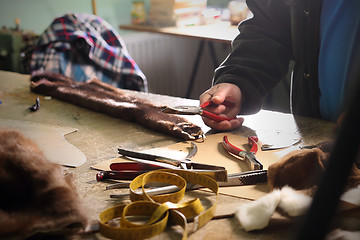 Image showing A tailor, leather craft Workshop furrier, utensils, tools and pieces of natural fur