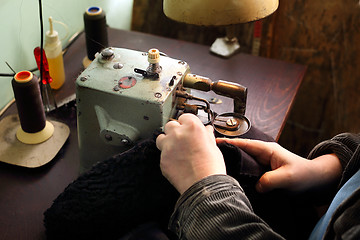 Image showing Furrier at the factory in the neck fur coat