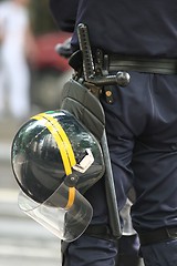 Image showing Helmet and truncheon on a police officer in the street