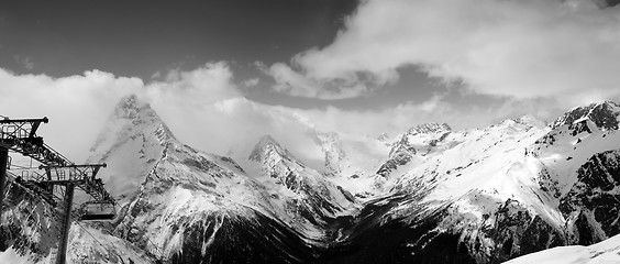 Image showing Black and white panoramic view on snow mountains in clouds