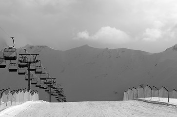 Image showing Black and white view on snow skiing piste and ropeway