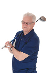 Image showing Senior man standing with golf iron.