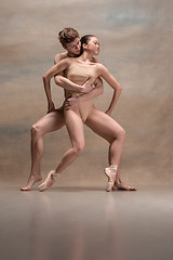 Image showing Couple of ballet dancers posing over gray background