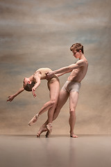 Image showing Couple of ballet dancers posing over gray background