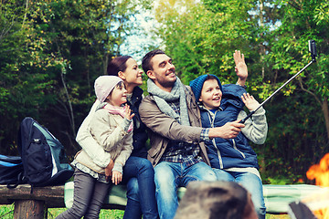 Image showing family with smartphone taking selfie near campfire