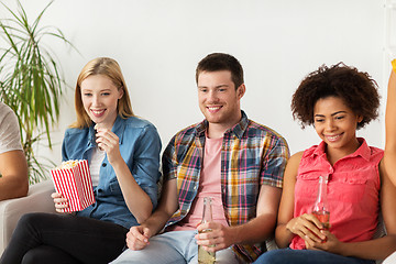 Image showing happy friends with popcorn watching tv at home