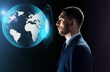 Image showing businessman looking at virtual earth projection