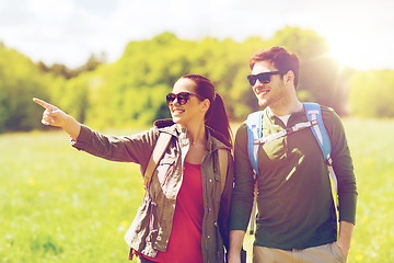 Image showing happy couple with backpacks hiking outdoors