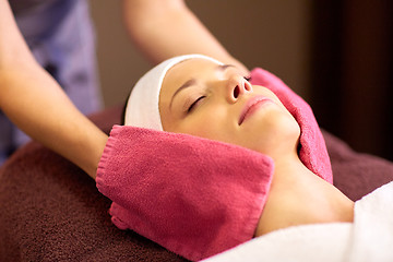 Image showing woman having face massage with terry gloves at spa